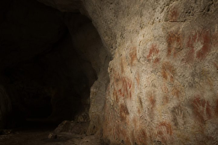 Prehistoric hand stencils on a cave wall