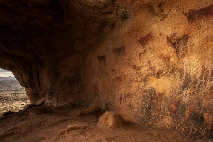 Painted rock shelter with ochre figures